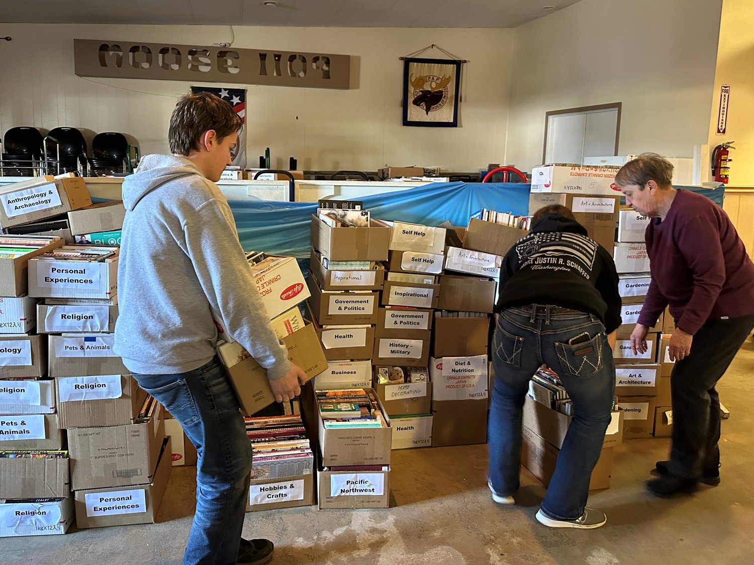 AAUW got some big help in preparing for the sale last Saturday as Scout Troop 373 helped move 700 boxes of books to the Moose Lodge. 